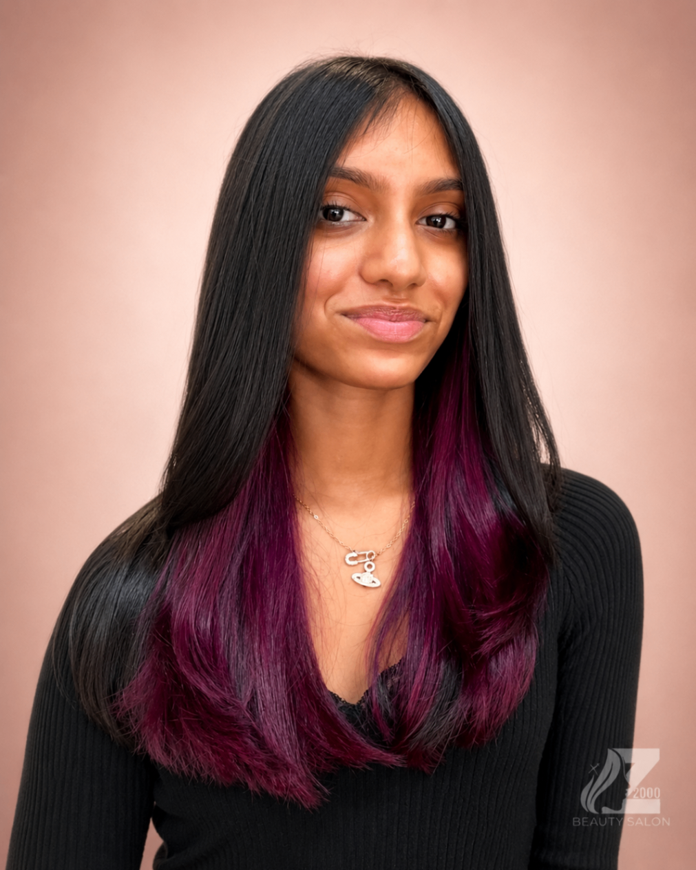 Black hair with plum peekaboo color and sleek finish