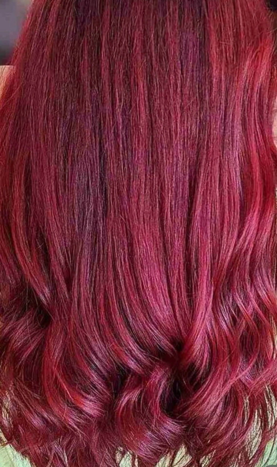 Deep burgundy red color result with soft waves and high shine